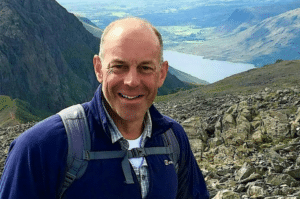 Phil Spencer with mountains and lake in the background